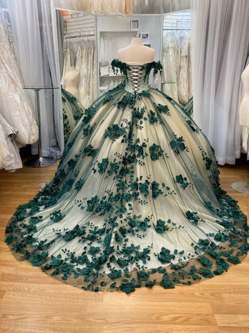 Quinceañera dress in champagne with emerald green flowers